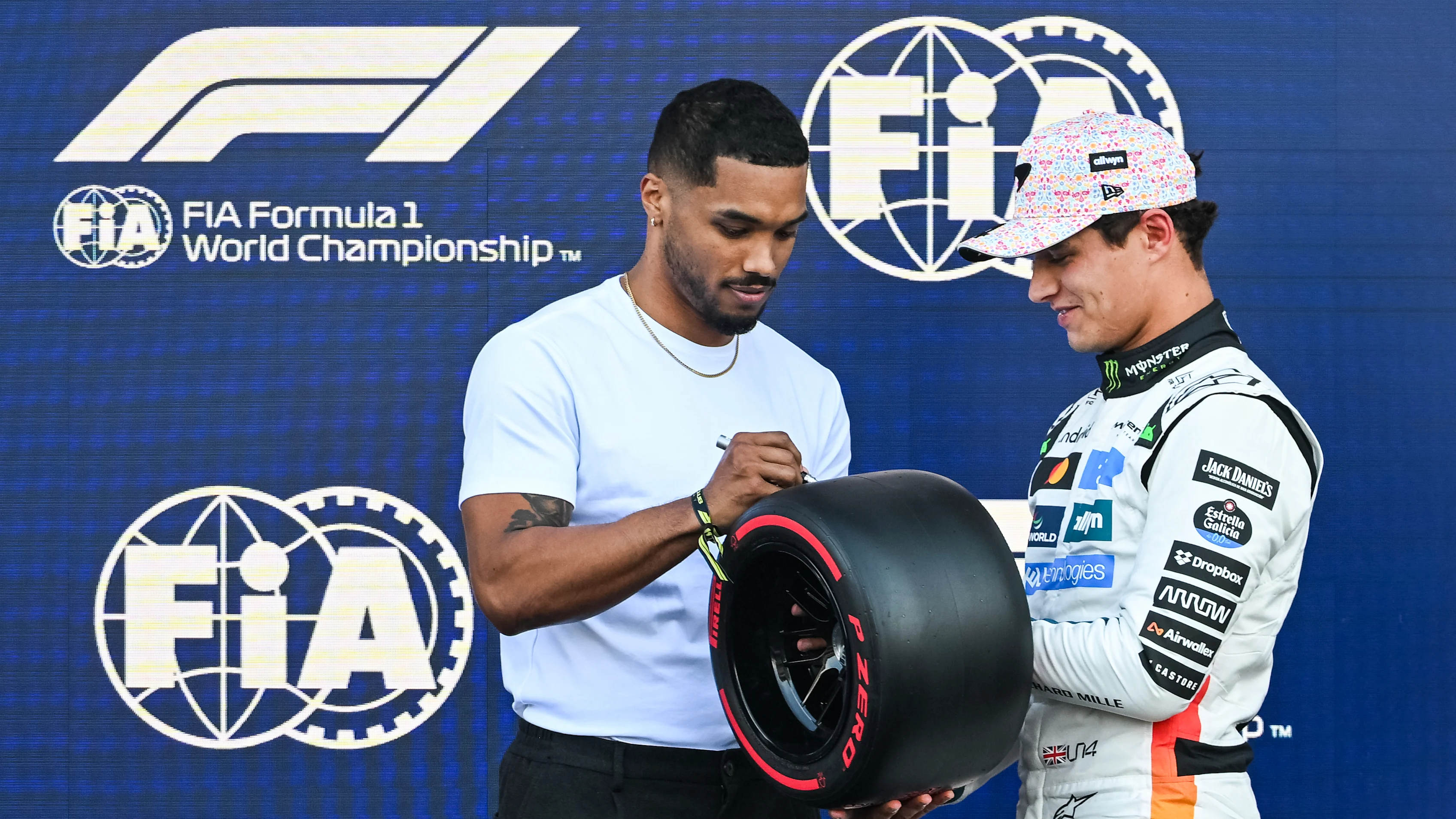 MEXICO CITY, MEXICO - OCTOBER 25: Rome Flynn presents Pole position qualifier Lando Norris of Great Britain and McLaren with his Pirelli Pole Position award during qualifying ahead of the F1 Grand Prix of Mexico at Autodromo Hermanos Rodriguez on October 25, 2025 in Mexico City, Mexico. (Photo by Rudy Carezzevoli/Getty Images)