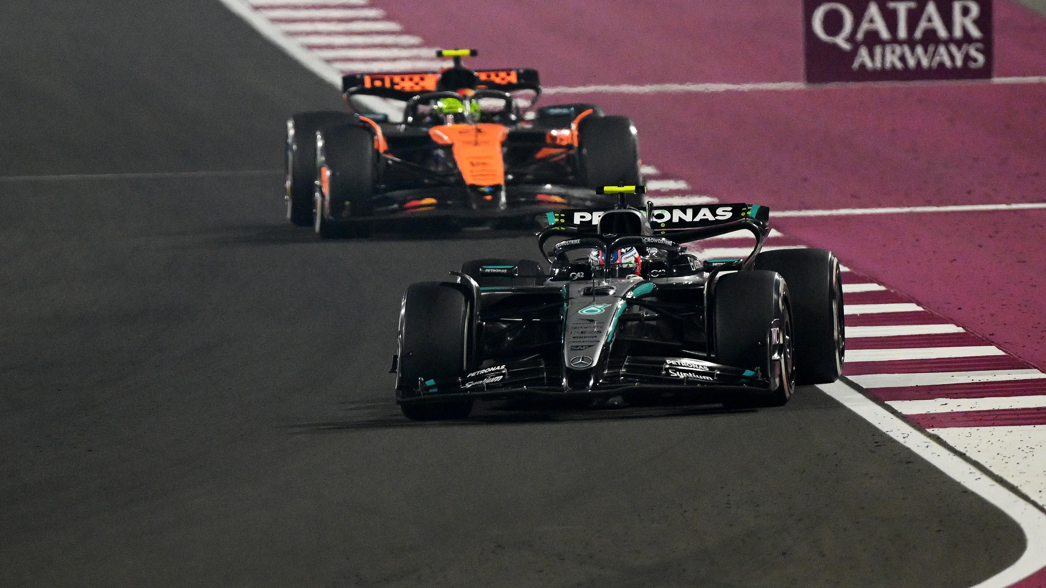 LUSAIL CITY, QATAR - NOVEMBER 30: Andrea Kimi Antonelli of Italy driving the (12) Mercedes AMG Petronas F1 Team W16 leads Lando Norris of Great Britain driving the (4) McLaren MCL39 Mercedes on track during the F1 Grand Prix of Qatar at Lusail International Circuit on November 30, 2025 in Lusail City, Qatar. (Photo by Clive Mason/Getty Images)