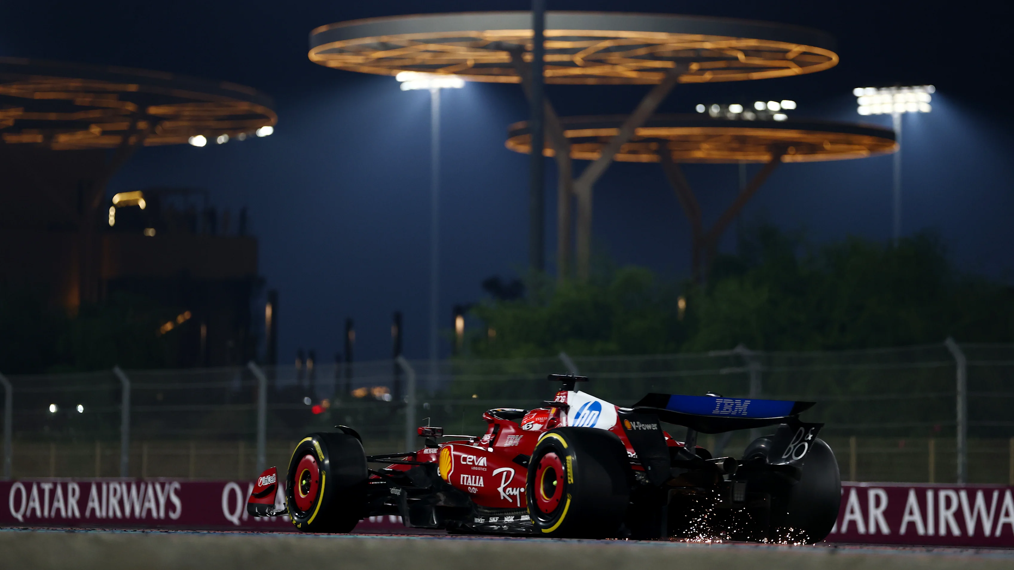 LUSAIL CITY, QATAR - NOVEMBER 30: Sparks fly behind Charles Leclerc of Monaco driving the (16) Scuderia Ferrari SF-25 on track during the F1 Grand Prix of Qatar at Lusail International Circuit on November 30, 2025 in Lusail City, Qatar. (Photo by Clive Rose - Formula 1/Formula 1 via Getty Images)