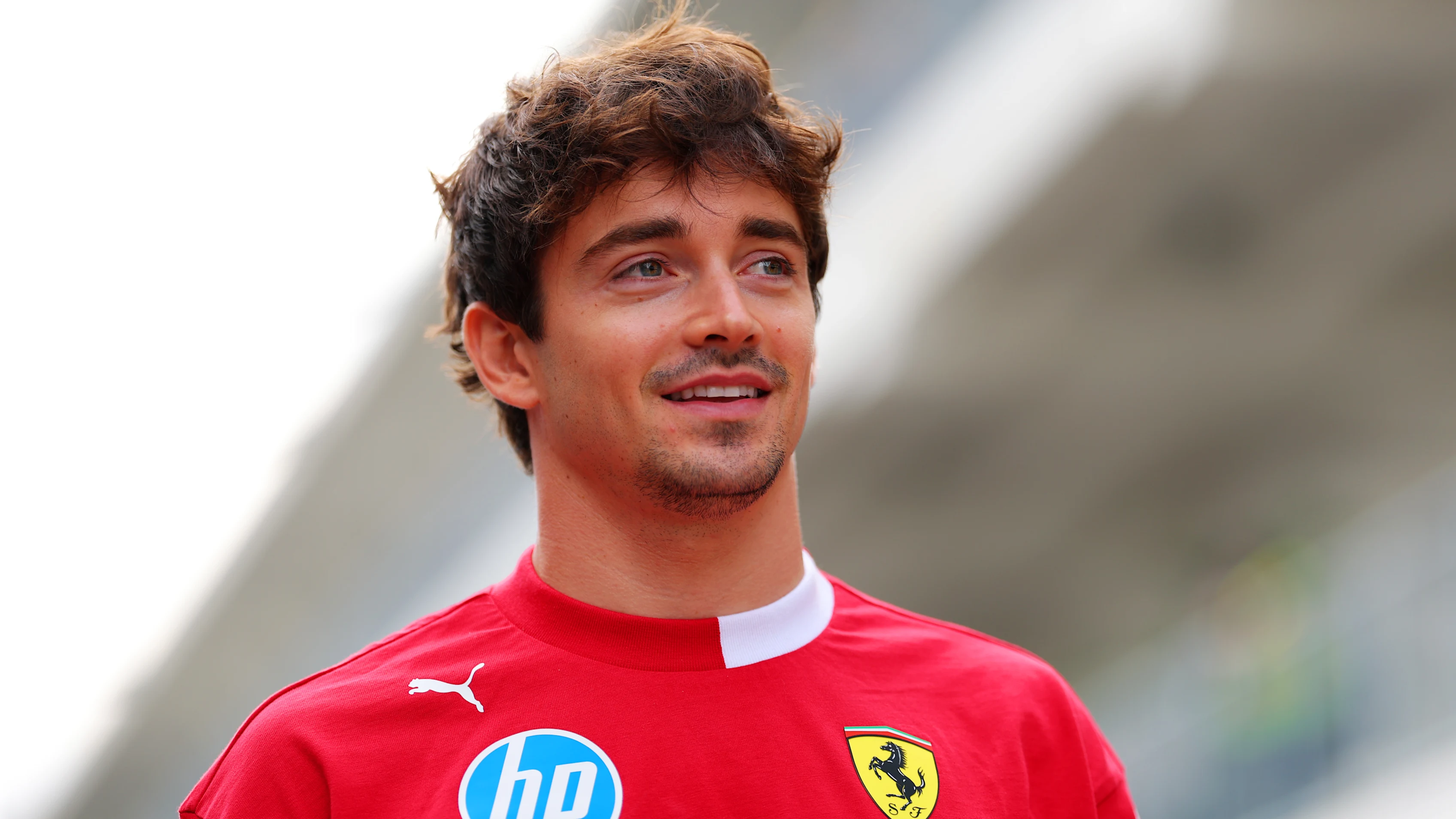 AUSTIN, TEXAS - OCTOBER 16: Charles Leclerc of Monaco and Scuderia Ferrari arrives in the Paddock