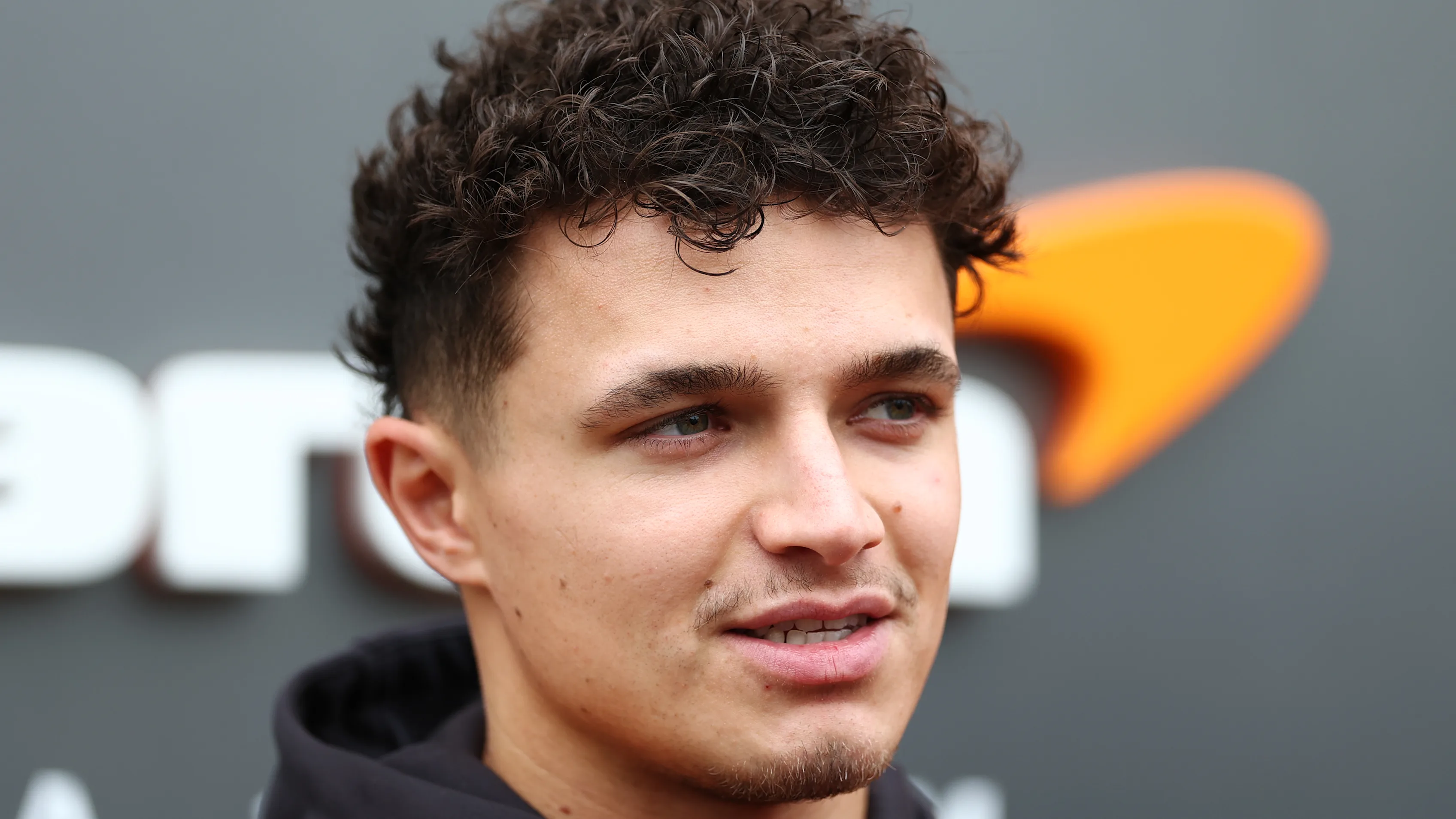BAHRAIN, BAHRAIN - FEBRUARY 27: Lando Norris of Great Britain and McLaren looks on in the Paddock
