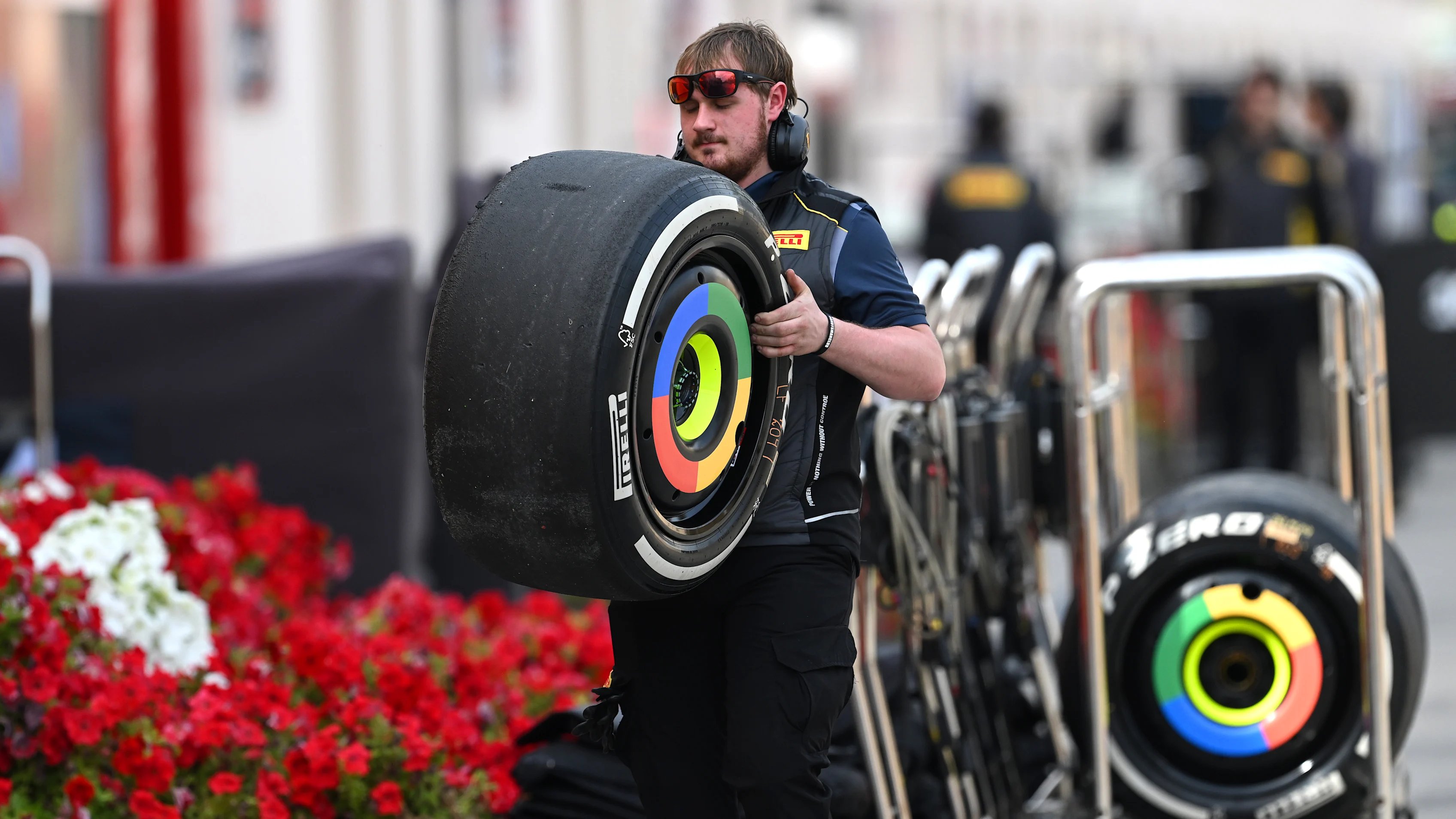 BAHRAIN, BAHRAIN - FEBRUARY 28: A team member of Pirelli carries a tyre in the Paddock during day