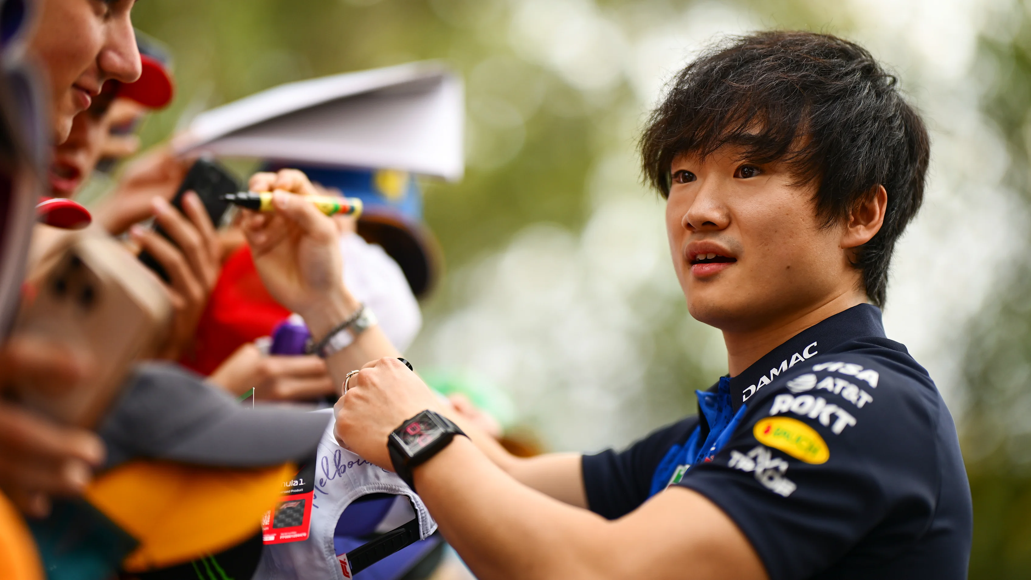 MELBOURNE, AUSTRALIA - MARCH 07: Yuki Tsunoda of Japan and Oracle Red Bull Racing signs autographs