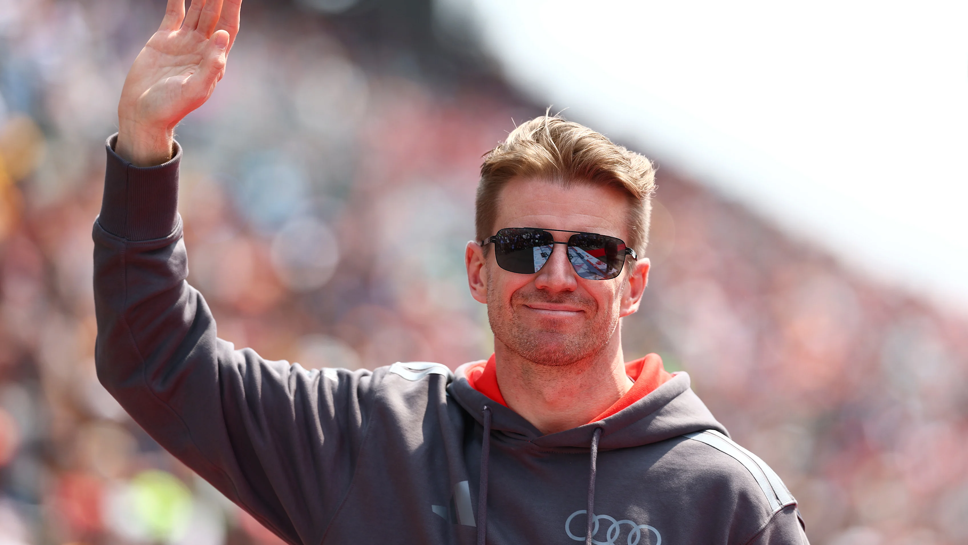 SUZUKA, JAPAN - MARCH 29: Nico Hulkenberg of Germany and Audi F1 Team waves on the drivers parade