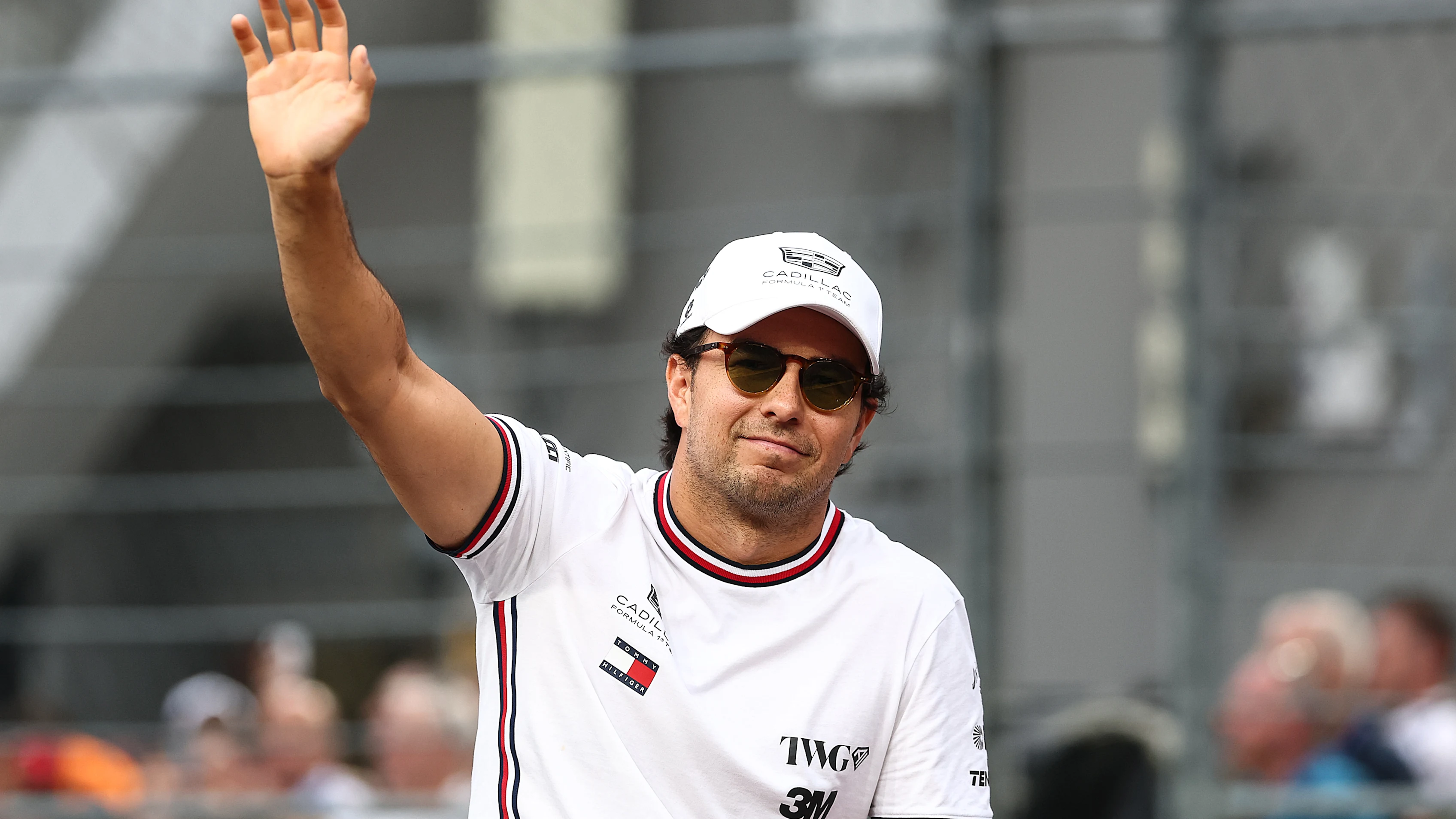 SINGAPORE, SINGAPORE - OCTOBER 11: Sergio Perez of Mexico and Cadillac F1 Team waves on the drivers