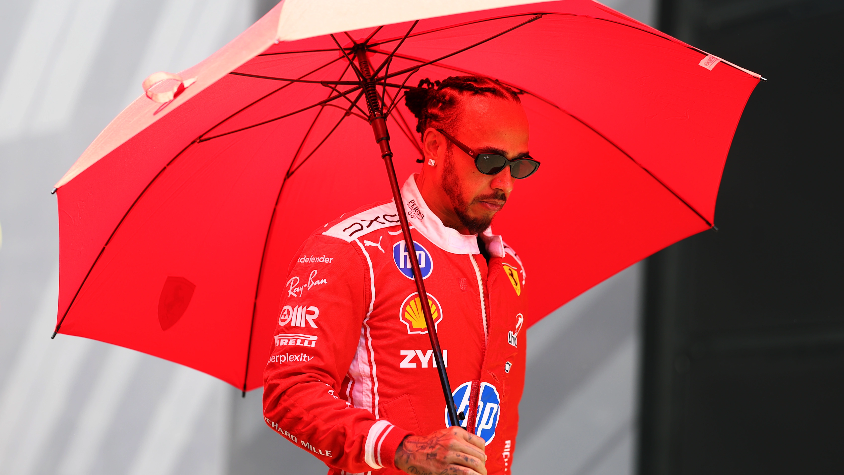 SPIELBERG, AUSTRIA - JUNE 25: Lewis Hamilton of Great Britain and Scuderia Ferrari walks in the