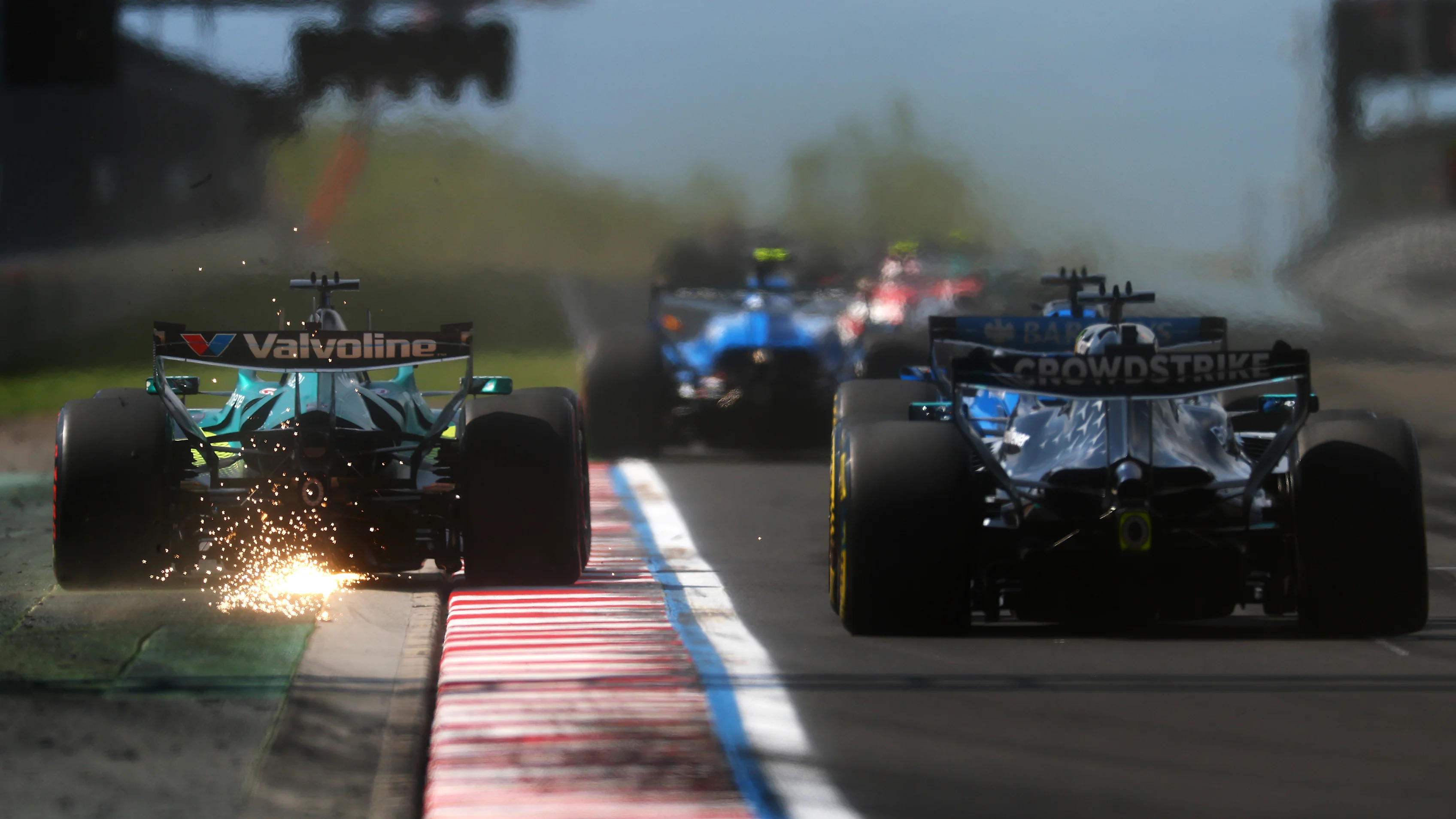 BUDAPEST, HUNGARY - JULY 26: Sparks fly behind Lance Stroll of Canada driving the (18) Aston Martin