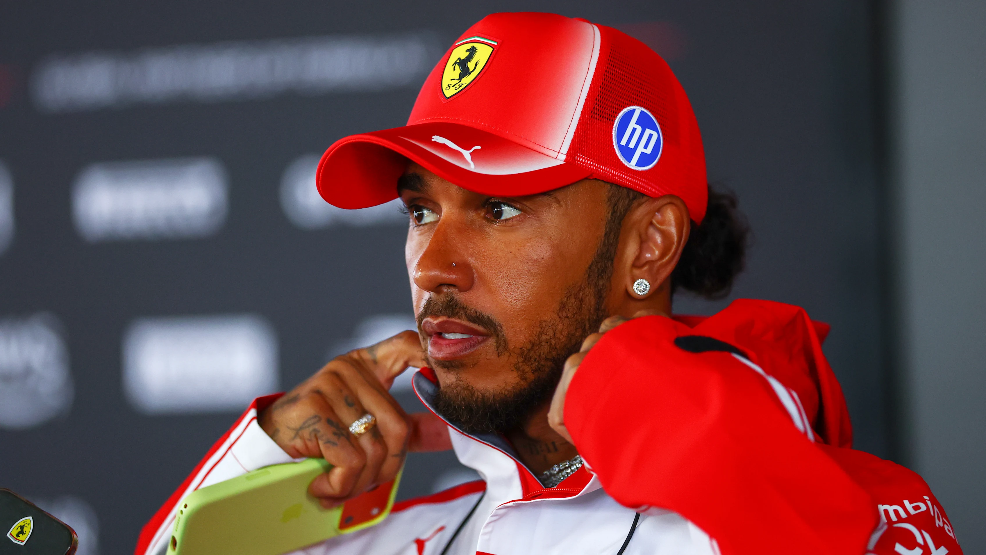 ZANDVOORT, NETHERLANDS - AUGUST 20: Lewis Hamilton of Great Britain and Scuderia Ferrari talks to