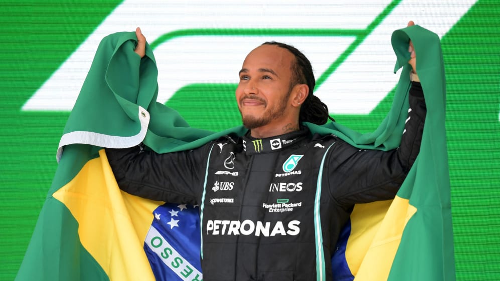 Mercedes' British driver Lewis Hamilton celebrates on the podium after winning Brazil's Formula One