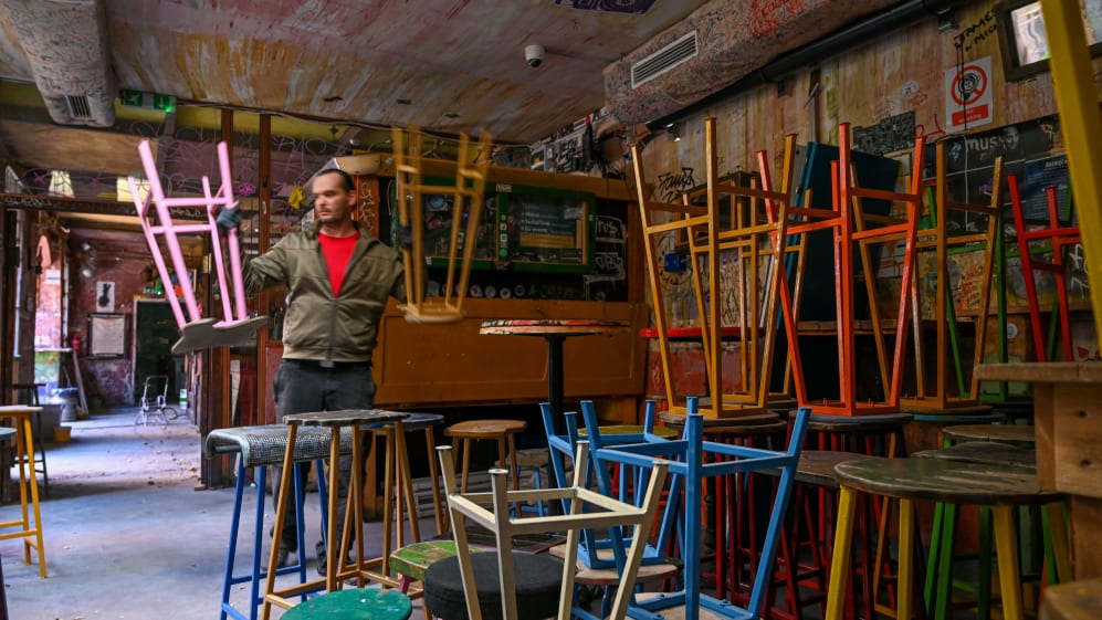 An employee moves bar stools in the famous ruin pub 'Szimpla Kert' (Simple Garden in Budapest,