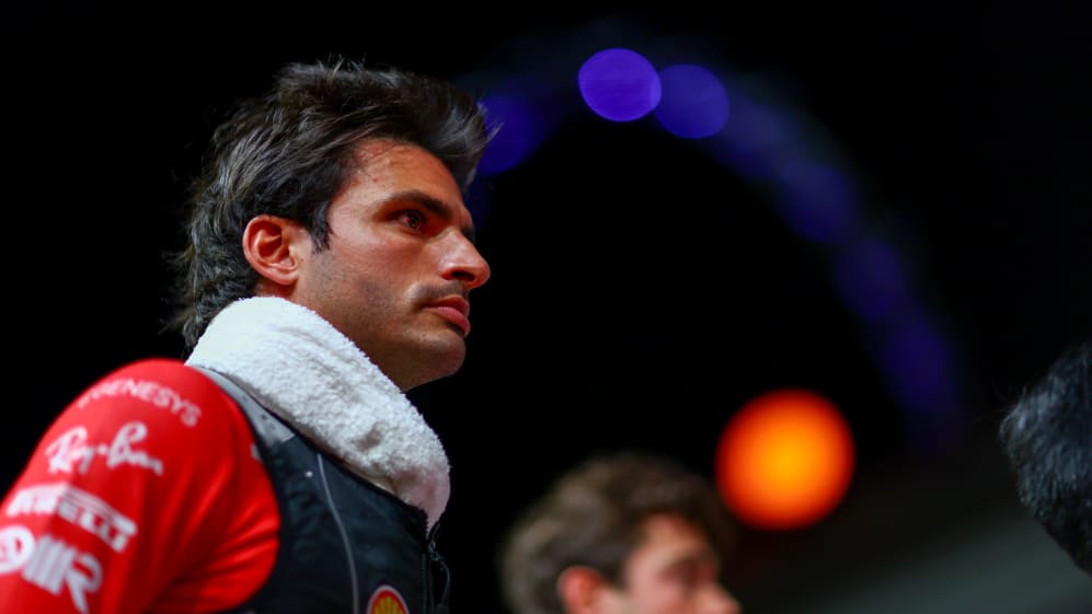 SINGAPORE, SINGAPORE - SEPTEMBER 17: Carlos Sainz of Spain and Ferrari looks on from the grid prior