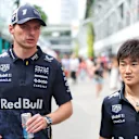 Max Verstappen and Yuki Tsunoda wearing the Red Bull x HYPEBEAST capsule collection, specifically designed for night races. Swipe for more images