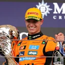 SAO PAULO, BRAZIL - NOVEMBER 09: Race winner Lando Norris of Great Britain and McLaren leaves the podium with his trophy and Champagne during the F1 Grand Prix of Brazil at Autodromo Jose Carlos Pace on November 09, 2025 in Sao Paulo, Brazil. (Photo by Anni Graf - Formula 1/Formula 1 via Getty Images)
