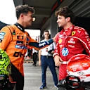 SAO PAULO, BRAZIL - NOVEMBER 08: Pole position qualifier Lando Norris of Great Britain and McLaren and Third placed qualifier Charles Leclerc of Monaco and Scuderia Ferrari talk in parc ferme during qualifying ahead of the F1 Grand Prix of Brazil at Autodromo Jose Carlos Pace on November 08, 2025 in Sao Paulo, Brazil. (Photo by Mark Sutton - Formula 1/Formula 1 via Getty Images)