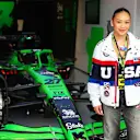 American artistic gymnast Suni Lee poses next to Nico Hulkenberg's Sauber