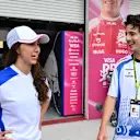 Actor Timothee Chalamet, in a Racing Bulls shirt, chats with Racing Bulls' F1 ACADEMY driver Rafaela Ferreira