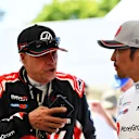 Haas and Komatsu have a chat around their runs up the hill