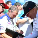 Haas signs autographs for fans at the side of the hillclimb course