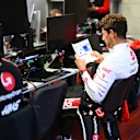 SCARPERIA, ITALY - SEPTEMBER 26: Romain Grosjean of France studies data in the garage before