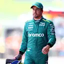 SPIELBERG, AUSTRIA - JUNE 29: 15th placed qualifier Fernando Alonso of Spain and Aston Martin F1 Team walks in the Pitlane during qualifying ahead of the F1 Grand Prix of Austria at Red Bull Ring on June 29, 2024 in Spielberg, Austria. (Photo by Bryn Lennon - Formula 1/Formula 1 via Getty Images)