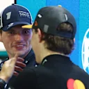 SINGAPORE, SINGAPORE - OCTOBER 04: Second placed qualifier Max Verstappen of the Netherlands and Oracle Red Bull Racing and Third placed qualifier Oscar Piastri of Australia and McLaren talk in parc ferme during qualifying ahead of the F1 Grand Prix of Singapore at Marina Bay Street Circuit on October 04, 2025 in Singapore, Singapore. (Photo by Mark Thompson/Getty Images)