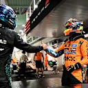 SINGAPORE, SINGAPORE - OCTOBER 04: Pole position qualifier George Russell of Great Britain and Mercedes AMG Petronas F1 Team and Third placed qualifier Oscar Piastri of Australia and McLaren congratulate each other in parc ferme during qualifying ahead of the F1 Grand Prix of Singapore at Marina Bay Street Circuit on October 04, 2025 in Singapore, Singapore. (Photo by Mark Sutton - Formula 1/Formula 1 via Getty Images)