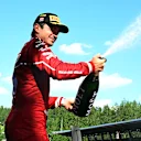 SPIELBERG, AUSTRIA - JUNE 29: Third placed Charles Leclerc of Monaco and Scuderia Ferrari sprays Champagne on the podium during the F1 Grand Prix of Austria at Red Bull Ring on June 29, 2025 in Spielberg, Austria. (Photo by Mark Sutton - Formula 1/Formula 1 via Getty Images)