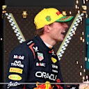 SAO PAULO, BRAZIL - NOVEMBER 09: Third placed Max Verstappen of the Netherlands and Oracle Red Bull Racing sprays Champagne on the podium during the F1 Grand Prix of Brazil at Autodromo Jose Carlos Pace on November 09, 2025 in Sao Paulo, Brazil. (Photo by Mark Thompson/Getty Images)