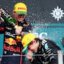 SAO PAULO, BRAZIL - NOVEMBER 09: Second placed Andrea Kimi Antonelli of Italy and Mercedes AMG Petronas F1 Team and Third placed Max Verstappen of the Netherlands and Oracle Red Bull Racing celebrate on the podium with Champagne during the F1 Grand Prix of Brazil at Autodromo Jose Carlos Pace on November 09, 2025 in Sao Paulo, Brazil. (Photo by Mark Thompson/Getty Images)