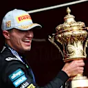 NORTHAMPTON, ENGLAND - JULY 06: Race winner Lando Norris of Great Britain and McLaren celebrates on the podium with his trophy during the F1 Grand Prix of Great Britain at Silverstone Circuit on July 06, 2025 in Northampton, England. (Photo by Mark Thompson/Getty Images)