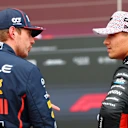 NORTHAMPTON, ENGLAND - JULY 05: Pole position qualifier Max Verstappen of the Netherlands and Oracle Red Bull Racing and Third placed qualifier Lando Norris of Great Britain and McLaren talk in parc ferme during qualifying ahead of the F1 Grand Prix of Great Britain at Silverstone Circuit on July 05, 2025 in Northampton, England. (Photo by Bryn Lennon - Formula 1/Formula 1 via Getty Images)