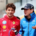 BUDAPEST, HUNGARY - AUGUST 03: Charles Leclerc of Monaco and Scuderia Ferrari and Franco Colapinto of Argentina and Alpine F1 talk on the drivers parade prior to the F1 Grand Prix of Hungary at Hungaroring on August 03, 2025 in Budapest, Hungary. (Photo by Clive Rose/Getty Images)