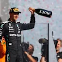 BUDAPEST, HUNGARY - AUGUST 03: Third placed George Russell of Great Britain and Mercedes AMG Petronas F1 Team on the podium during the F1 Grand Prix of Hungary at Hungaroring on August 03, 2025 in Budapest, Hungary. (Photo by Mark Thompson/Getty Images)