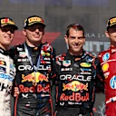 AUSTIN, TEXAS - OCTOBER 19: Race winner Max Verstappen of the Netherlands and Oracle Red Bull Racing Second placed Lando Norris of Great Britain and McLaren Third placed Charles Leclerc of Monaco and Scuderia Ferrari and Chris Gent, Chief Mechanic at Oracle Red Bull Racing on the podium during the F1 Grand Prix of United States at Circuit of The Americas on October 19, 2025 in Austin, Texas. (Photo by Meg Oliphant/Getty Images)