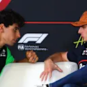 AUSTIN, TEXAS - OCTOBER 16: Gabriel Bortoleto of Brazil and Stake F1 Team Kick Sauber talks with Max Verstappen of the Netherlands and Oracle Red Bull Racing in the Drivers Press Conference during previews ahead of the F1 Grand Prix of United States at Circuit of The Americas on October 16, 2025 in Austin, Texas. (Photo by Clive Rose/Getty Images)