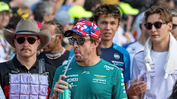 (L-R) Alfa Romeo's Finnish driver Valtteri Bottas, Aston Martin's Spanish driver Fernando Alonso,