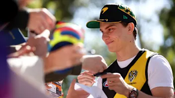 McLaren's Australian driver Oscar Piastri signs autographs for fans at the Albert Park Circuit