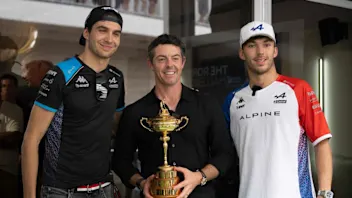 Golfer Rory McIlroy (C), of Northern Ireland, holds the Ryder Cup as he poses with Alpine's French