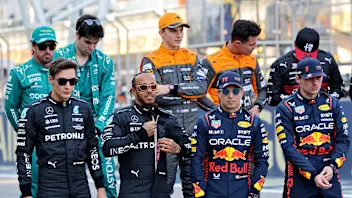 (Front L to R) Mercedes' British driver George Russell and British driver Lewis Hamilton, and Red