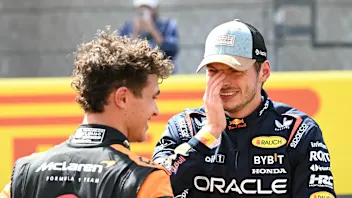 Red Bull Racing's Dutch driver Max Verstappen (R) speaks with McLaren's British driver Lando