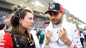 BAHRAIN, BAHRAIN - APRIL 13: Laura Mueller, Race Engineer of Haas F1 and Esteban Ocon of France and