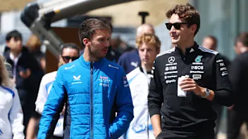 SUZUKA, JAPAN - APRIL 03: Pierre Gasly of France and Alpine F1 talks with George Russell of Great