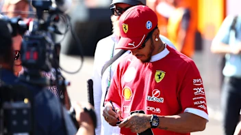 BUDAPEST, HUNGARY - JULY 31: Lewis Hamilton of Great Britain and Scuderia Ferrari signs autographs
