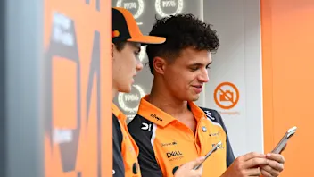 BAHRAIN, BAHRAIN - APRIL 13: Race winner Oscar Piastri of Australia and McLaren lifts his trophy on