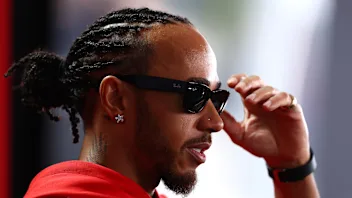 SUZUKA, JAPAN - MARCH 26: Lewis Hamilton of Great Britain and Scuderia Ferrari talks to the media