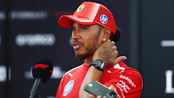 SINGAPORE, SINGAPORE - OCTOBER 08: Lewis Hamilton of Great Britain and Scuderia Ferrari talks to