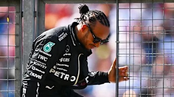 NORTHAMPTON, ENGLAND - JULY 07: Lewis Hamilton of Great Britain and Mercedes climbs through a pit