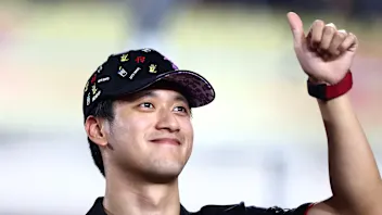 LUSAIL CITY, QATAR - OCTOBER 08: Zhou Guanyu of China and Alfa Romeo F1 waves to the crowd on the