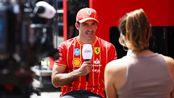 SPIELBERG, AUSTRIA - JUNE 27: Carlos Sainz of Spain and Ferrari talks to the media in the Paddock