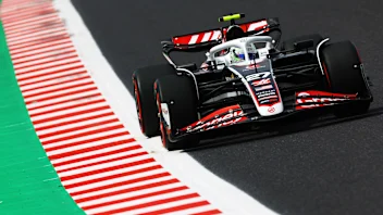 SUZUKA, JAPAN - APRIL 7: Kevin Magnussen of Denmark and MoneyGram Haas F1 Team and Nico Hulkenberg